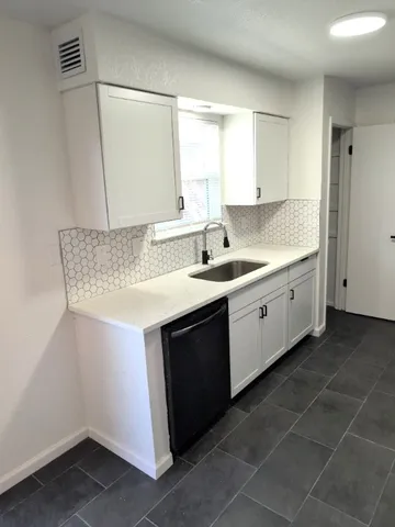 a kitchen with a sink and large window