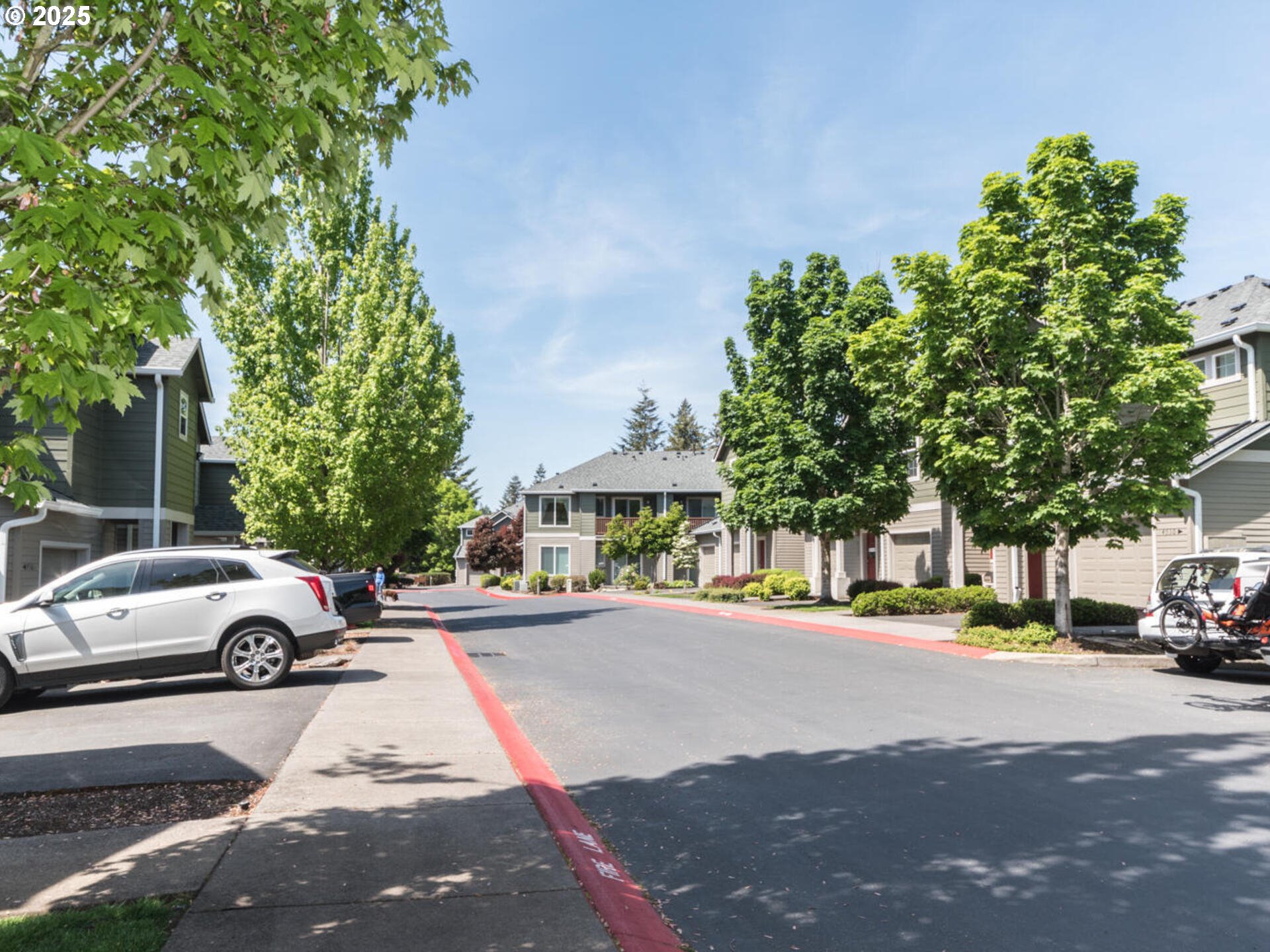 4556 Southwest 11th Street Gresham, OR 97080 - Photo 3 of 31 a city street lined with buildings and cars