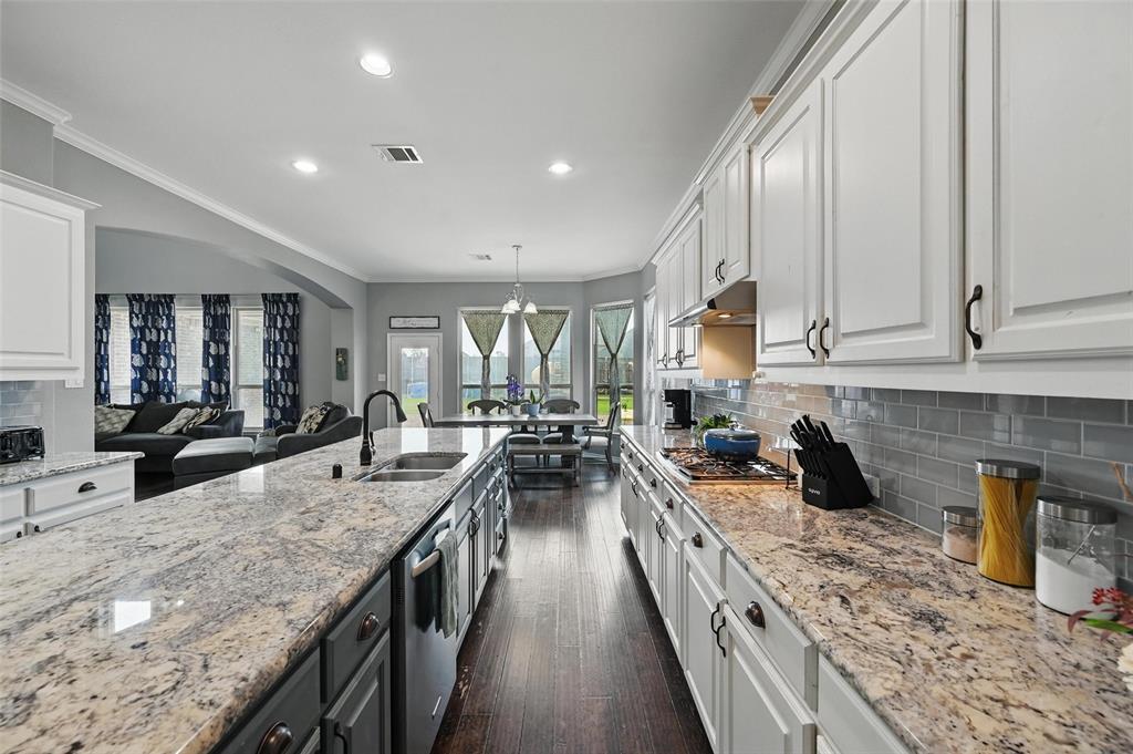 408 Mission Drive Forney, TX 75126 - Photo 11 of 40 Kitchen with a sink, stainless steel appliances, white cabinetry, recessed lighting, and dark wood finished floors