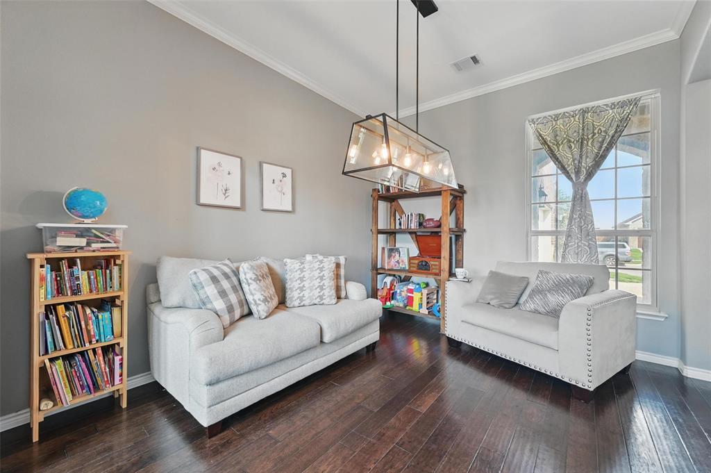 408 Mission Drive Forney, TX 75126 - Photo 21 of 40 Living room featuring hardwood / wood-style flooring, baseboards, and ornamental molding