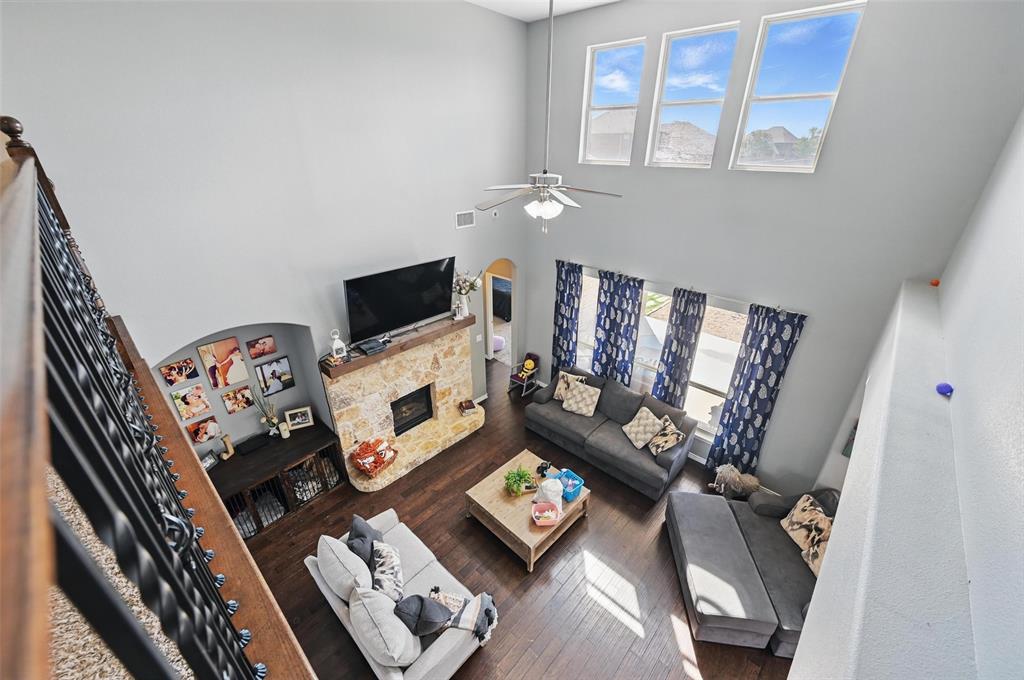 408 Mission Drive Forney, TX 75126 - Photo 23 of 40 Living area with plenty of natural light, a high ceiling, wood finished floors, ceiling fan, and arched walkways