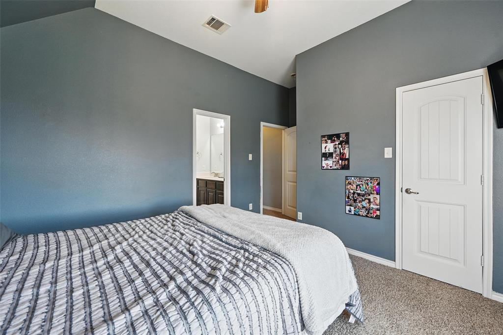408 Mission Drive Forney, TX 75126 - Photo 25 of 40 Carpeted bedroom featuring high vaulted ceiling, baseboards, ceiling fan, and ensuite bathroom
