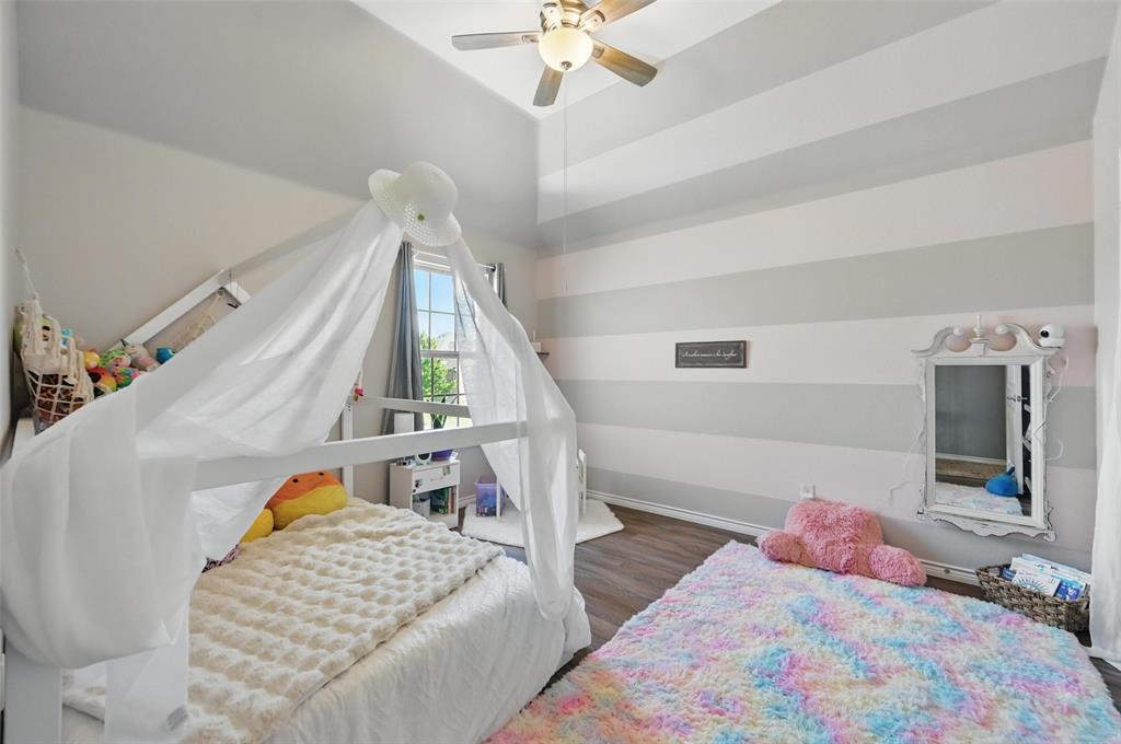 408 Mission Drive Forney, TX 75126 - Photo 27 of 40 Bedroom with wood finished floors, a ceiling fan, and baseboards
