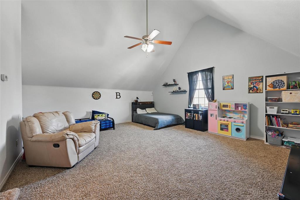 408 Mission Drive Forney, TX 75126 - Photo 29 of 40 Bedroom with carpet floors, baseboards, ceiling fan, and high vaulted ceiling