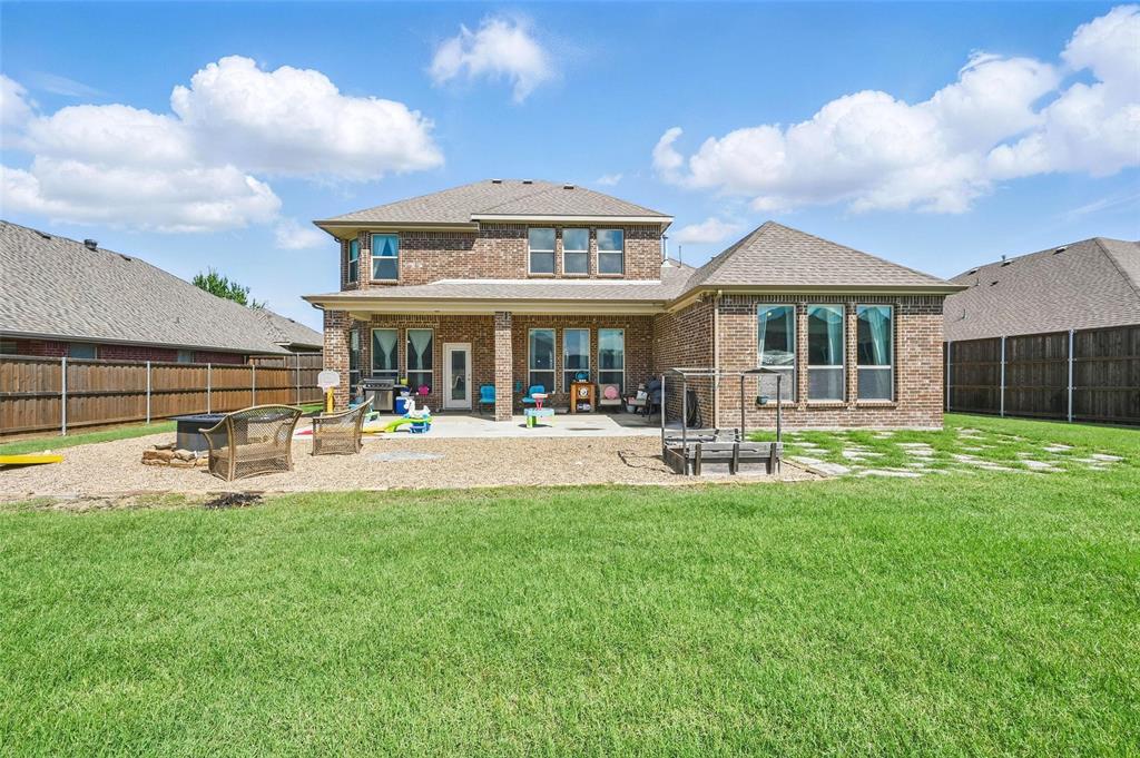 408 Mission Drive Forney, TX 75126 - Photo 33 of 40 Back of property with a patio, brick siding, and a shingled roof