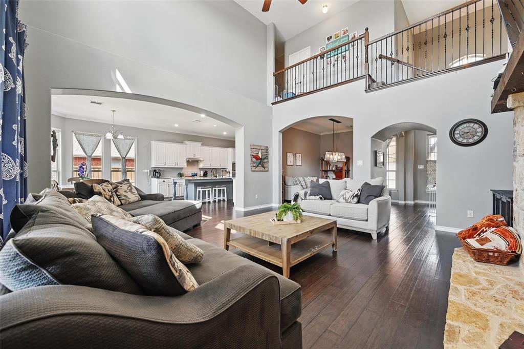 408 Mission Drive Forney, TX 75126 - Photo 5 of 40 Living area with arched walkways, ceiling fan, dark wood-style floors, plenty of natural light, and a towering ceiling
