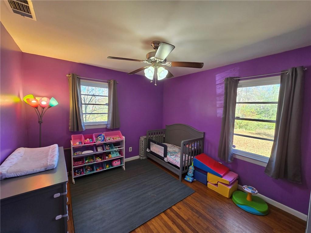 130 Trentwood Place Northwest Rome, GA 30165 - Photo 11 of 15 a living room with furniture a bed and a chandelier