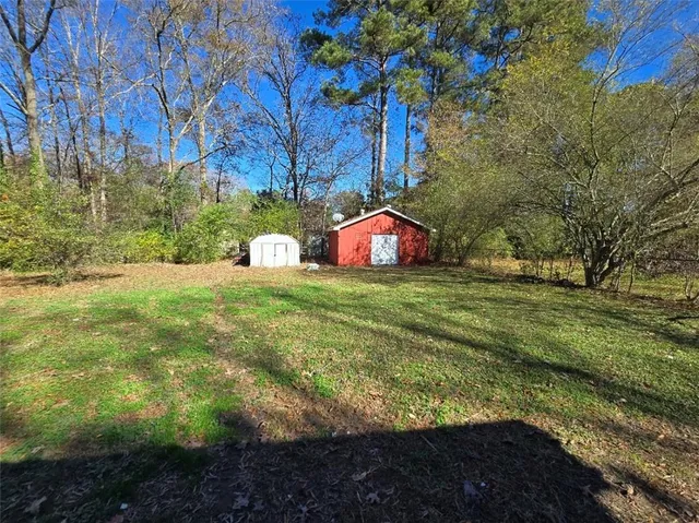 a view of a garden with large trees