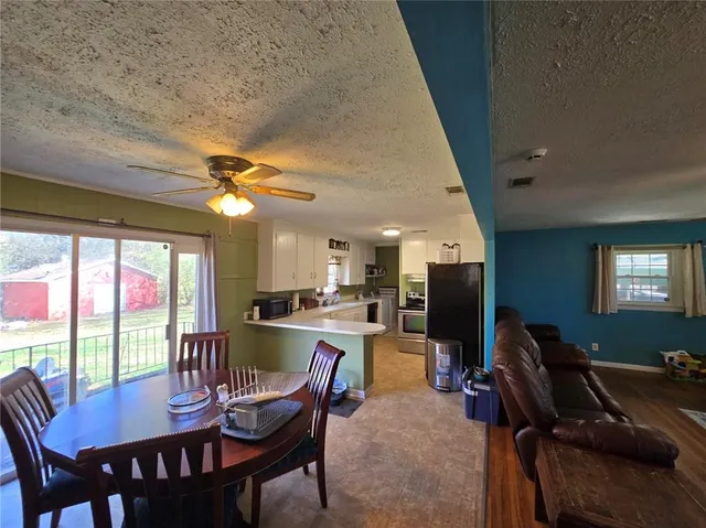 a view of a dining room with furniture window and outside view