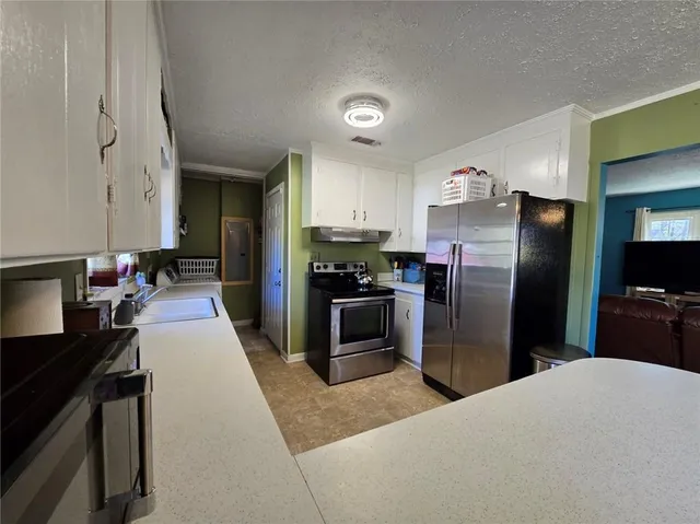 a kitchen with a refrigerator and a sink