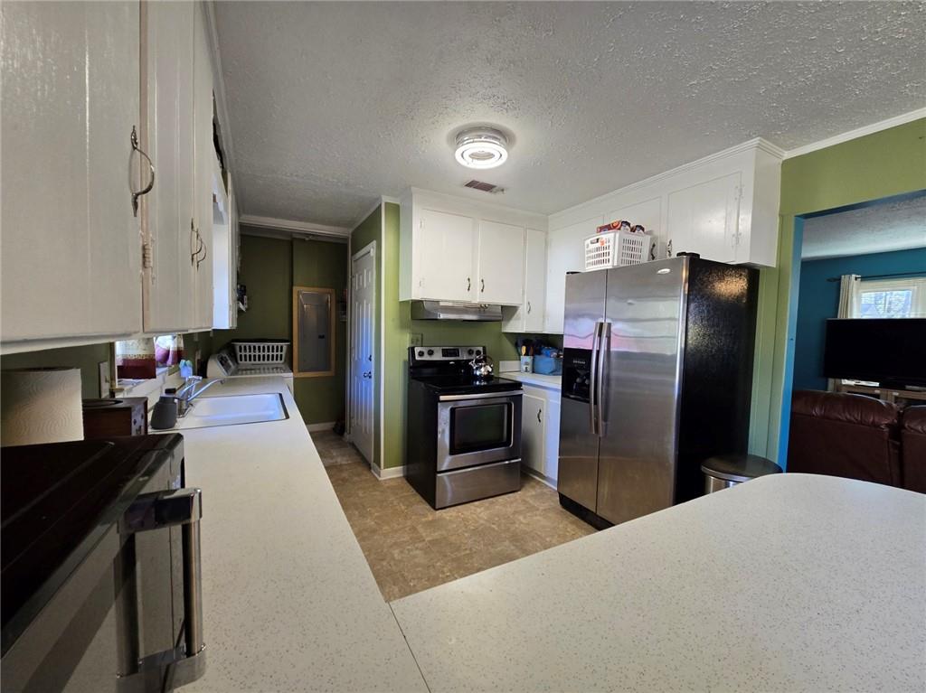 130 Trentwood Place Northwest Rome, GA 30165 - Photo 7 of 15 a kitchen with a refrigerator and a sink