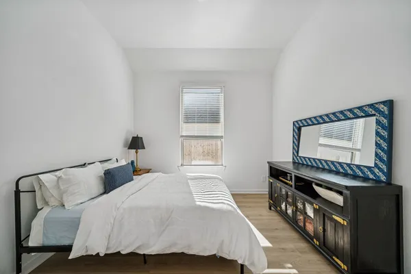 a bedroom with a bed and a window