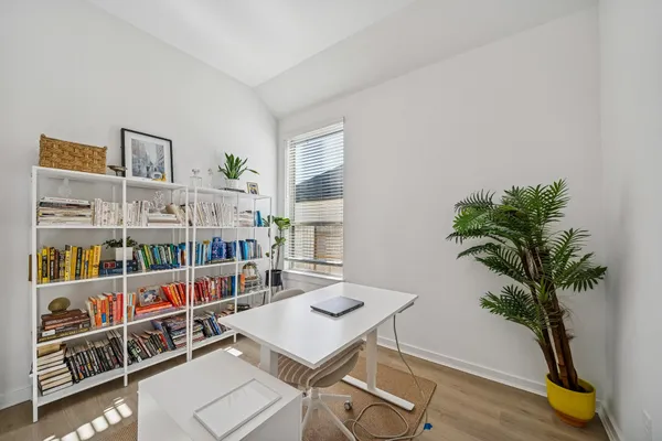 a dining room with furniture a chandelier and wooden floor