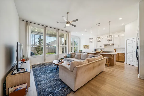 a living room with furniture flat screen tv and a fireplace