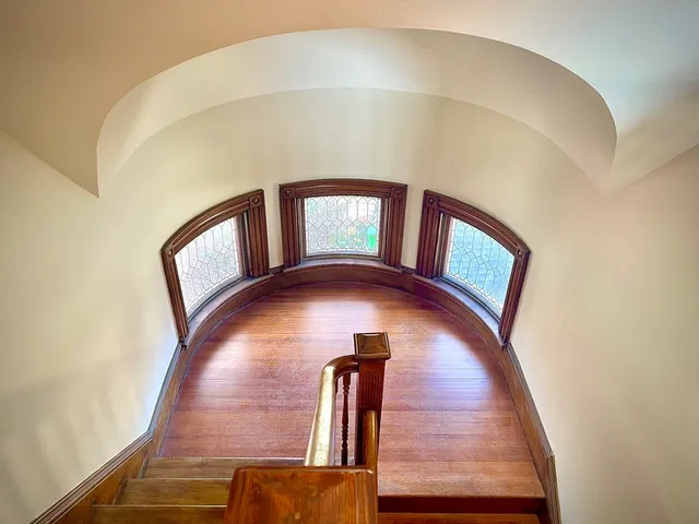 a view of staircase with a hallway