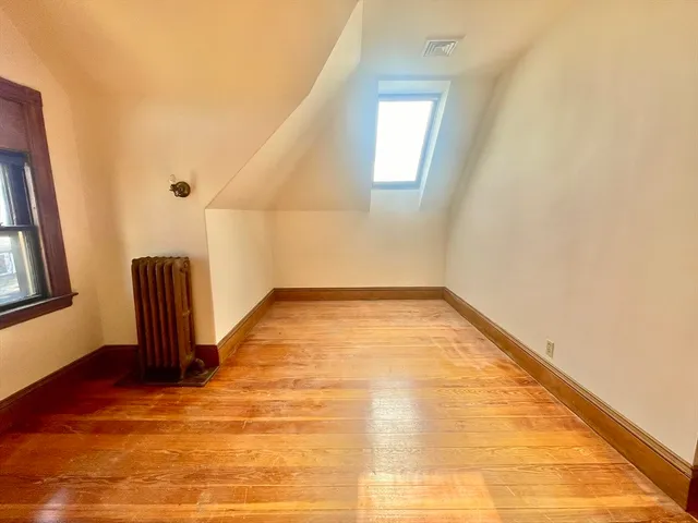 a view of a livingroom with wooden floor and staircase