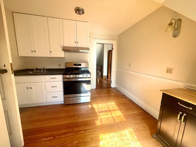 a kitchen with granite countertop a stove and a refrigerator