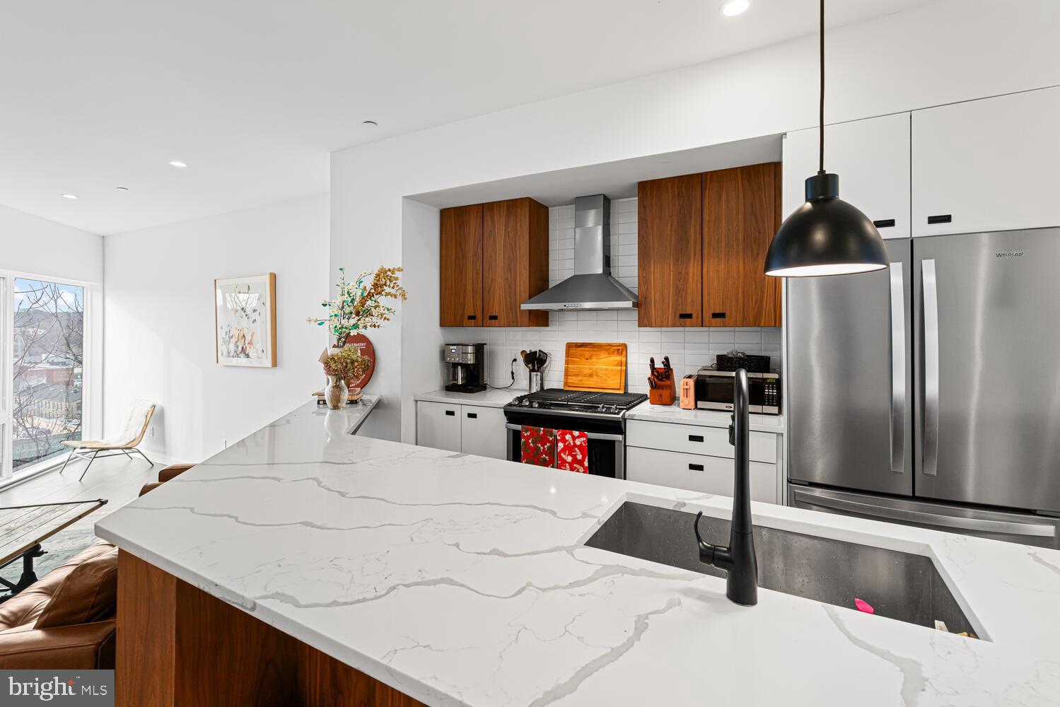 237 Krams Avenue Philadelphia, PA 19128 - Photo 1 of 31 a kitchen with stainless steel appliances kitchen island granite countertop a refrigerator a stove and a sink with wooden floor