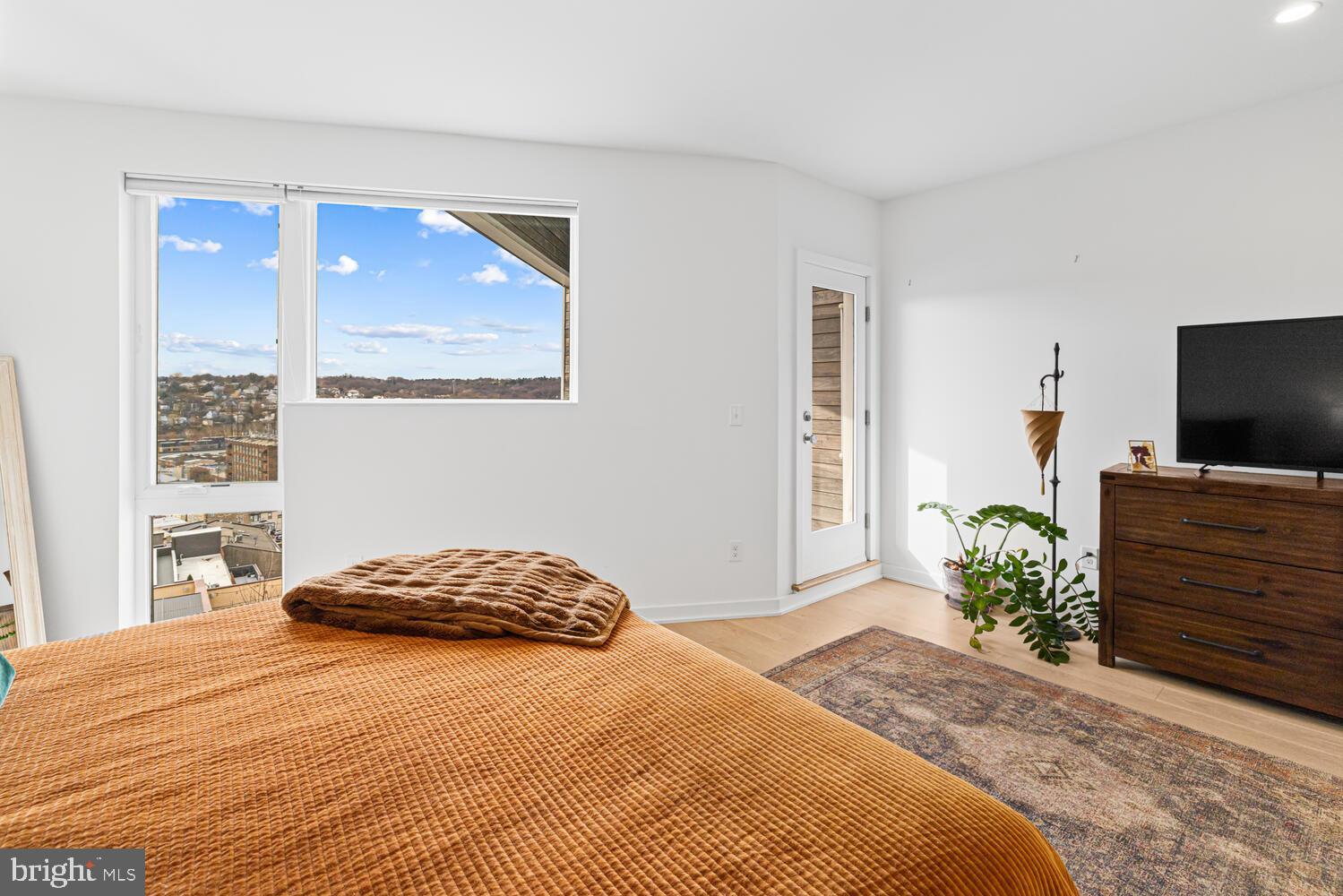 237 Krams Avenue Philadelphia, PA 19128 - Photo 12 of 31 a bedroom with a bed and a flat screen tv