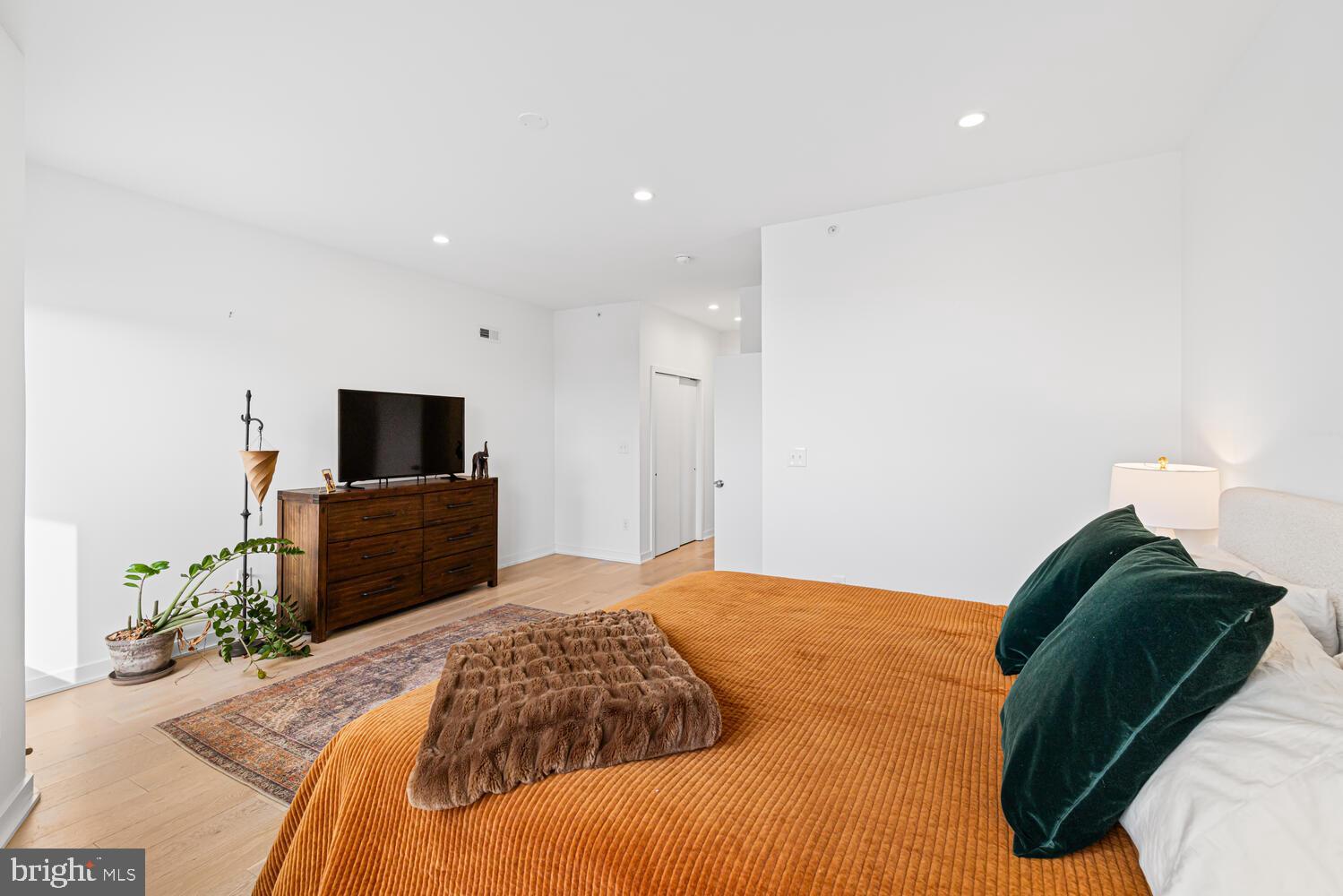 237 Krams Avenue Philadelphia, PA 19128 - Photo 13 of 31 a bedroom with a bed and a flat screen tv