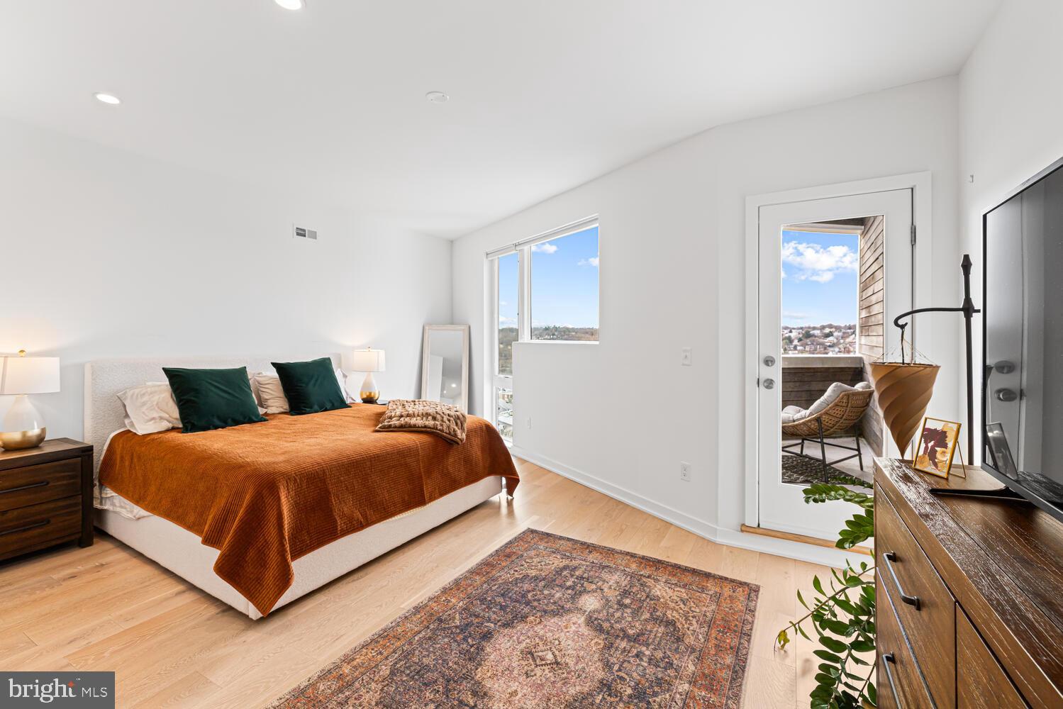 237 Krams Avenue Philadelphia, PA 19128 - Photo 14 of 31 a bedroom with a bed and wooden floor