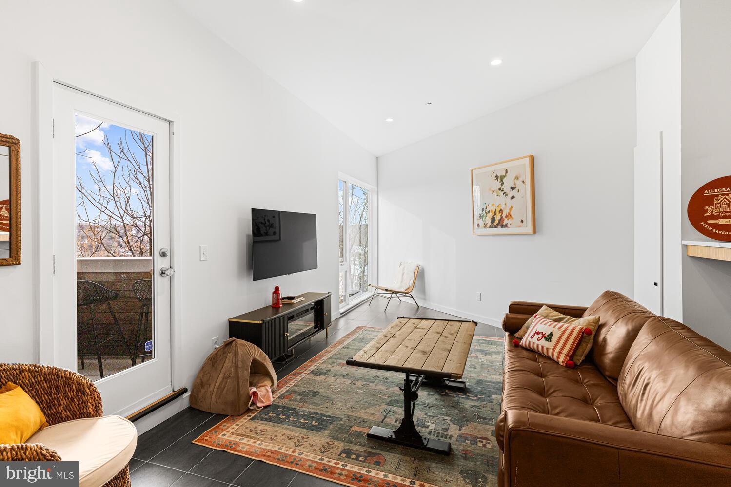237 Krams Avenue Philadelphia, PA 19128 - Photo 3 of 31 a living room with furniture and a flat screen tv