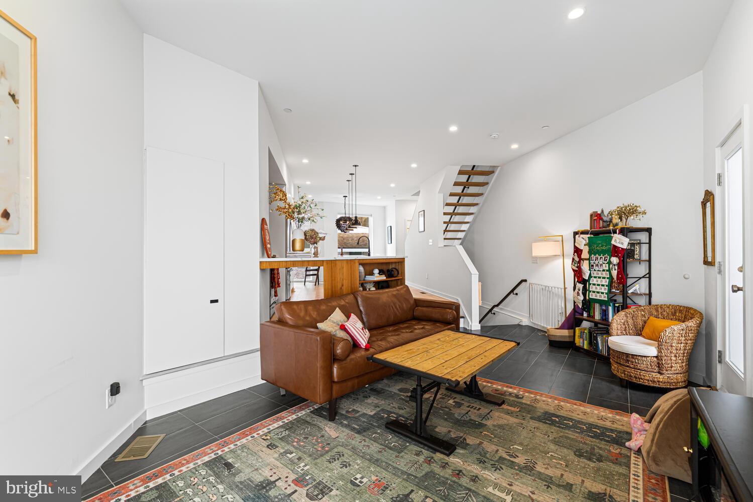 237 Krams Avenue Philadelphia, PA 19128 - Photo 4 of 31 a living room with furniture a rug and gym equipment