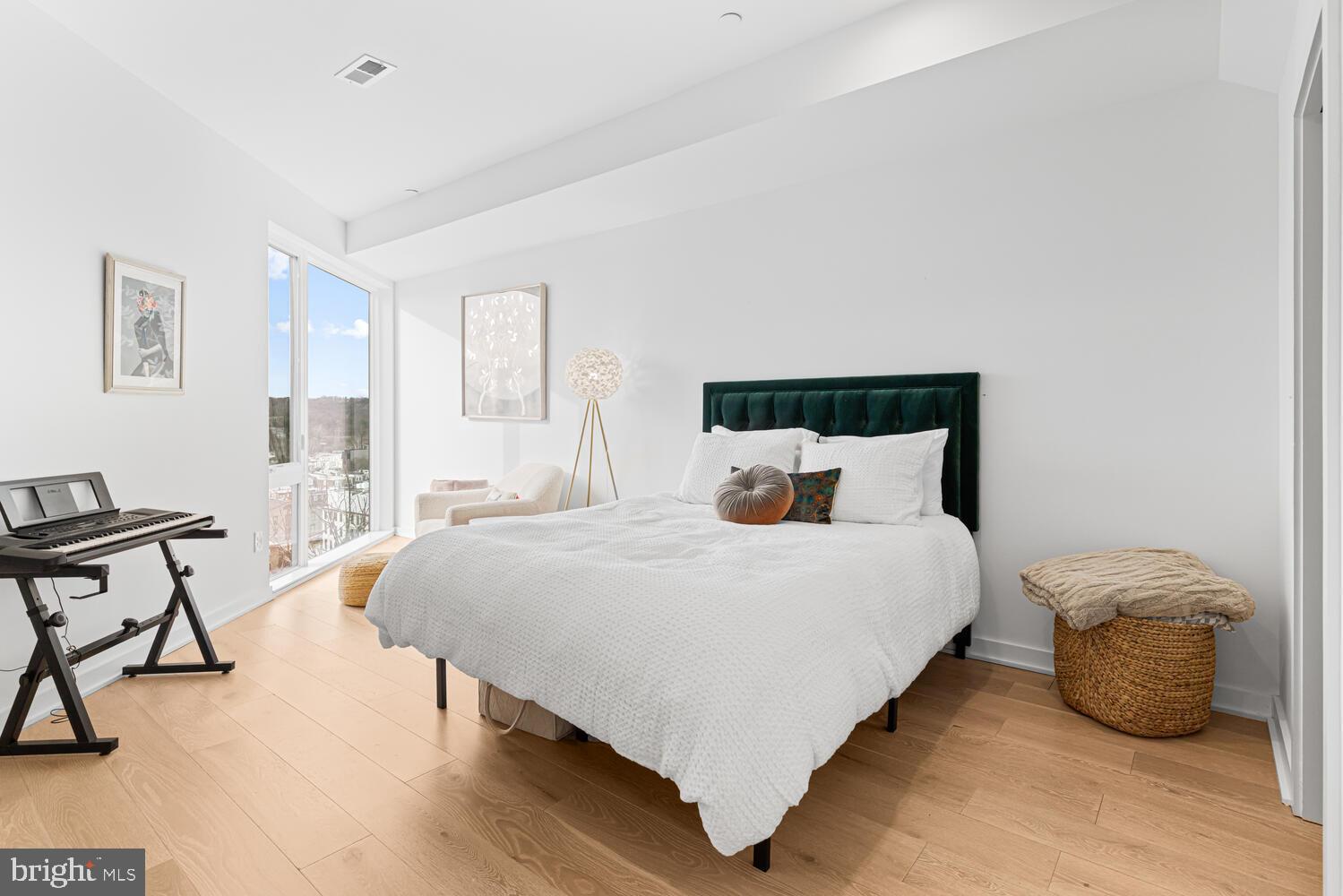 237 Krams Avenue Philadelphia, PA 19128 - Photo 9 of 31 a large bed sitting in a bedroom next to a window with a lamp and a table