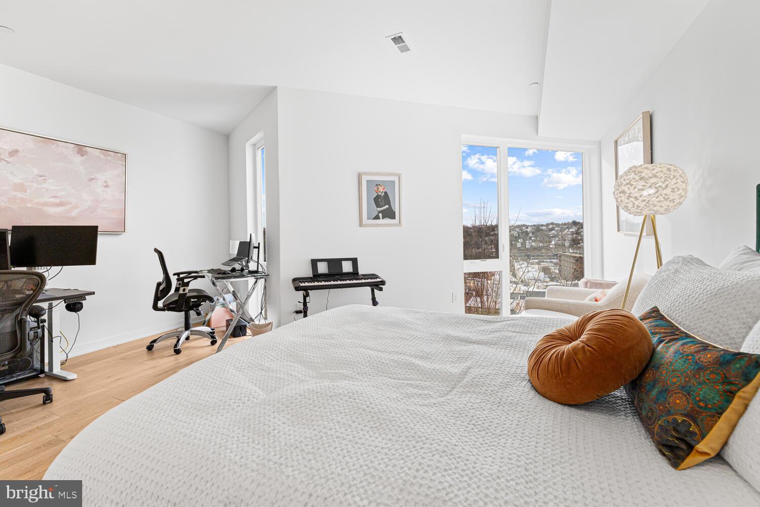 237 Krams Avenue Philadelphia, PA 19128 - Photo 10 of 31 a bedroom with bed and a flat tv screen on dresser
