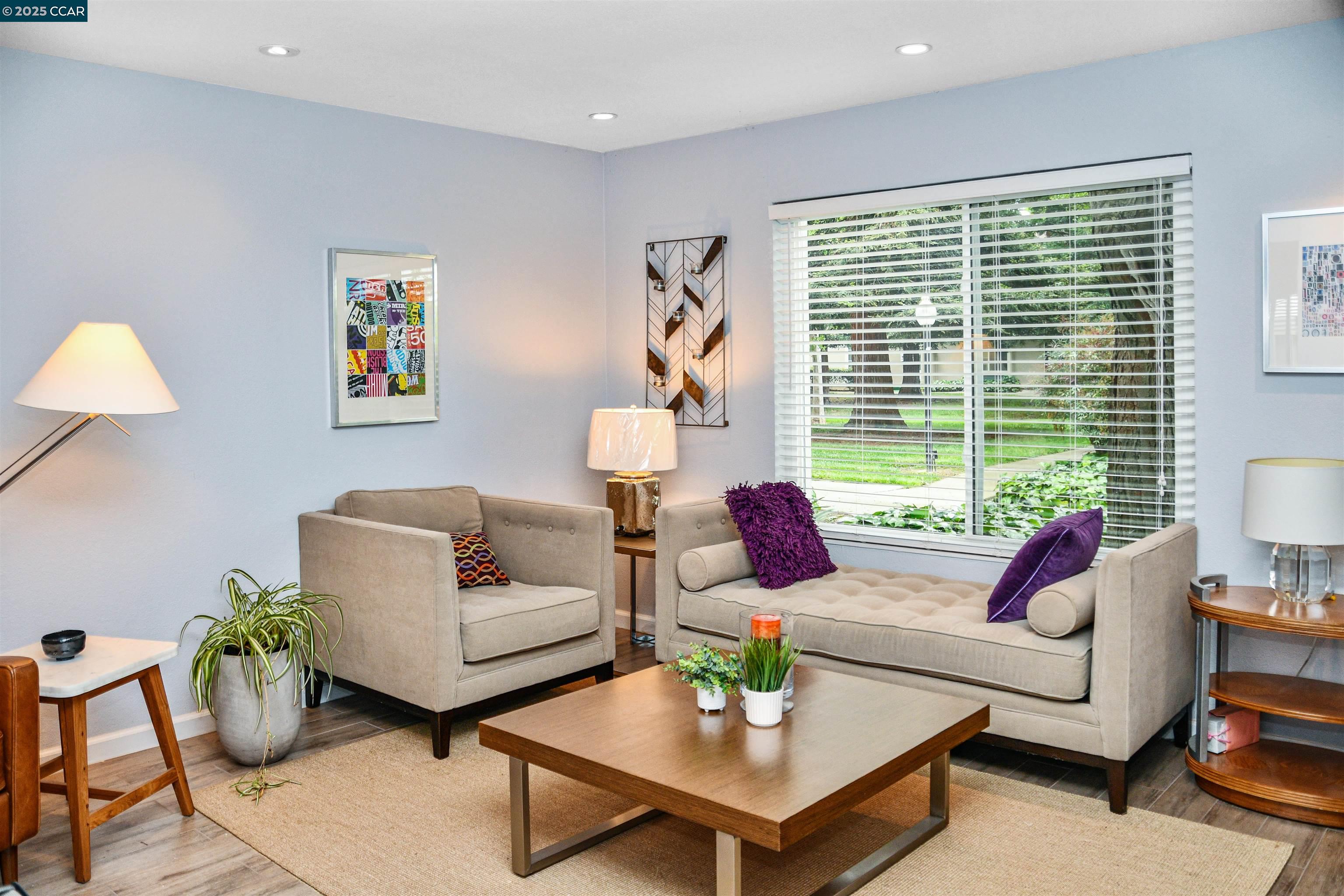 a living room with furniture and a large window