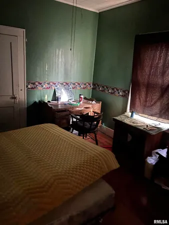 a bed sitting in a bedroom next to a window
