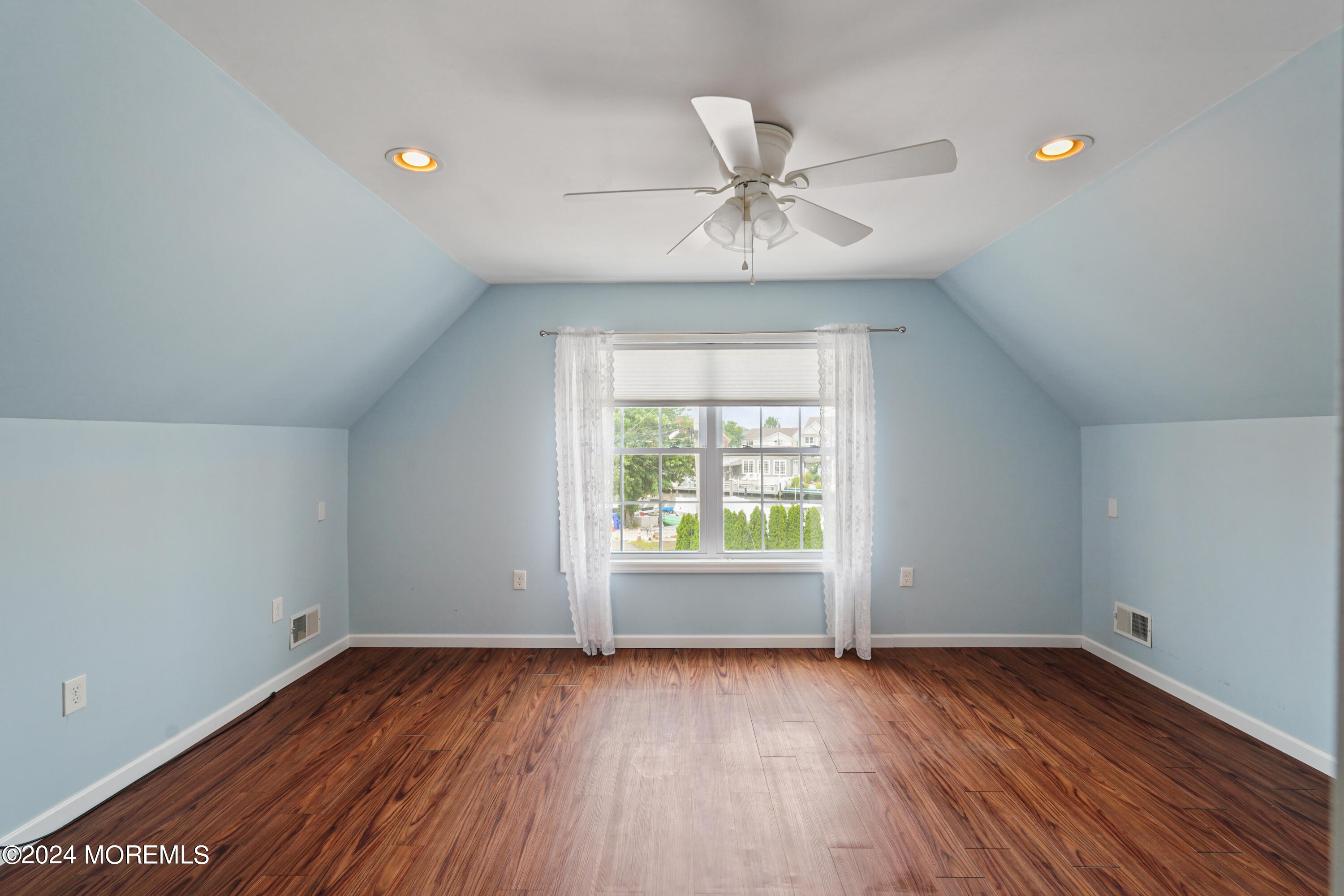 2 Topsail Road Brick, NJ 08723 - Photo 24 of 69 an empty room with wooden floor fan and windows
