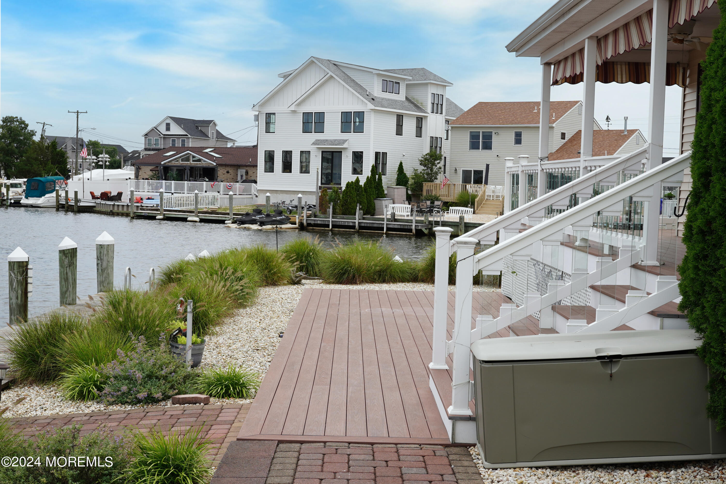 2 Topsail Road Brick, NJ 08723 - Photo 57 of 69 a view of a lake with a white house next to a yard