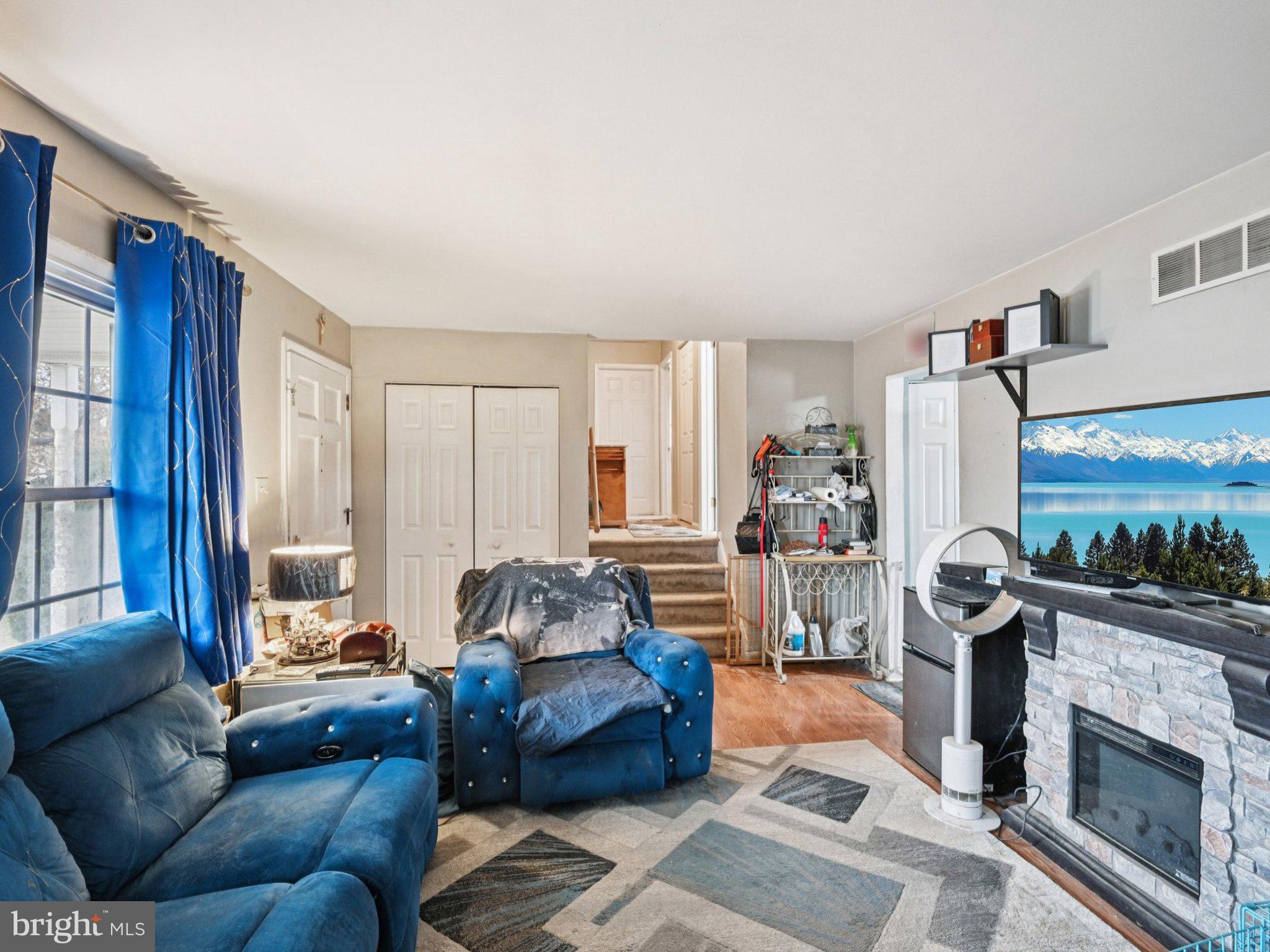 170 Scottfield Drive Newark, DE 19713 - Photo 5 of 28 a living room with furniture a fireplace and a flat screen tv
