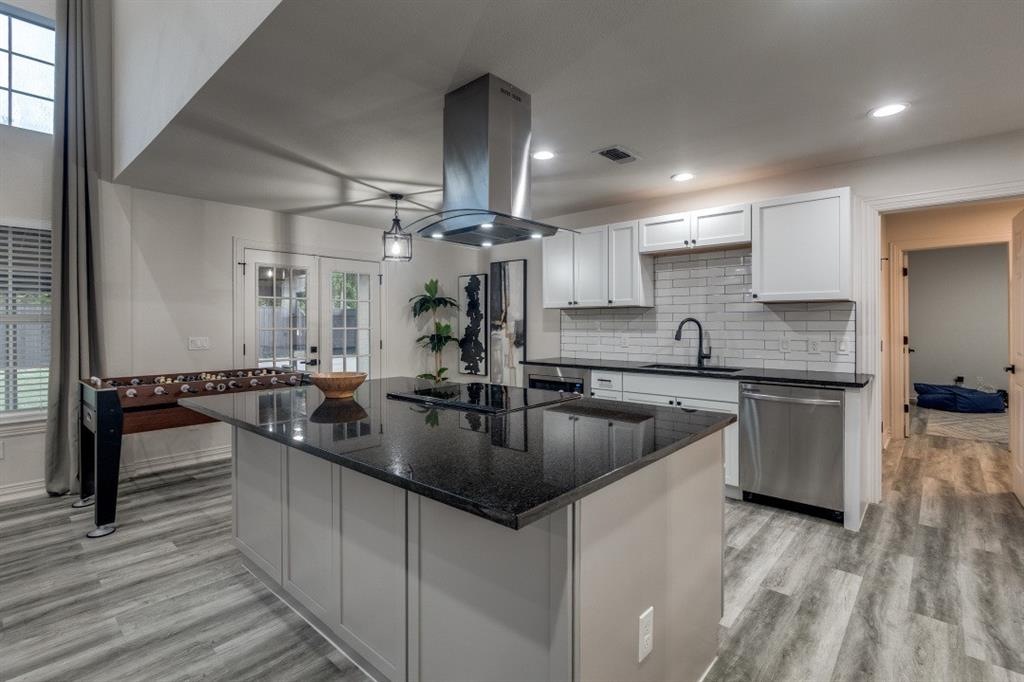 3304 Inwood Road Dallas, TX 75235 - Photo 11 of 24 a kitchen with counter top space a sink cabinets and appliances