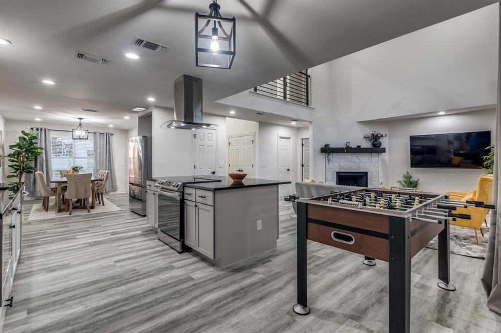 3304 Inwood Road Dallas, TX 75235 - Photo 13 of 24 a kitchen with stainless steel appliances kitchen island granite countertop a table chairs sink and cabinets