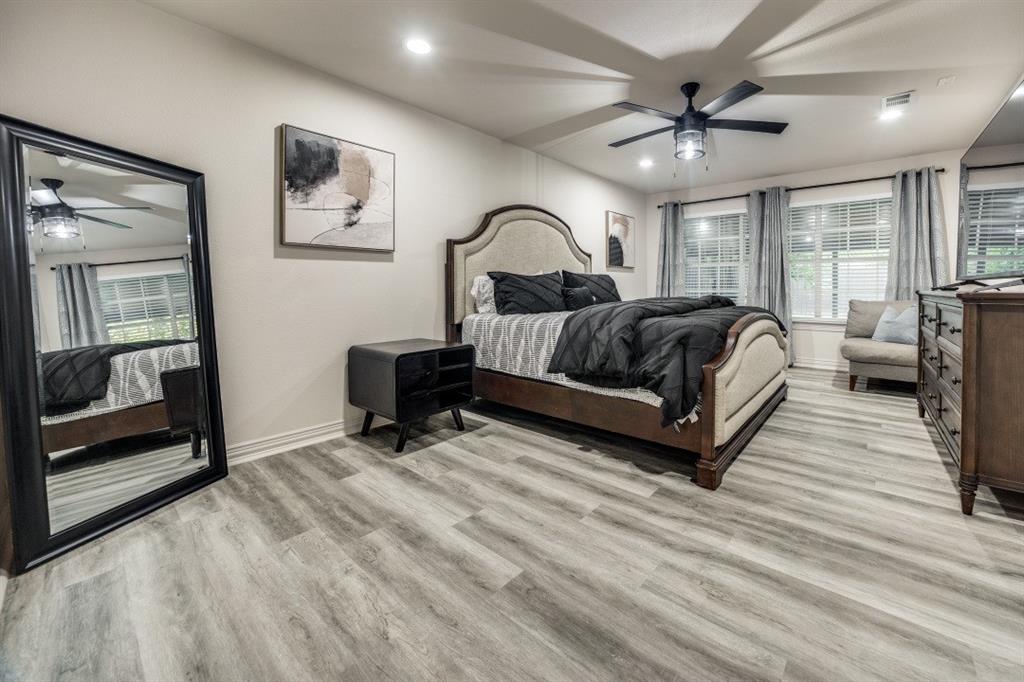 3304 Inwood Road Dallas, TX 75235 - Photo 14 of 24 a spacious bedroom with a bed couch and a window