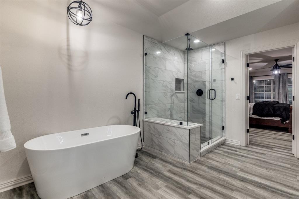 3304 Inwood Road Dallas, TX 75235 - Photo 15 of 24 a bathroom with a tub a sink and a shower