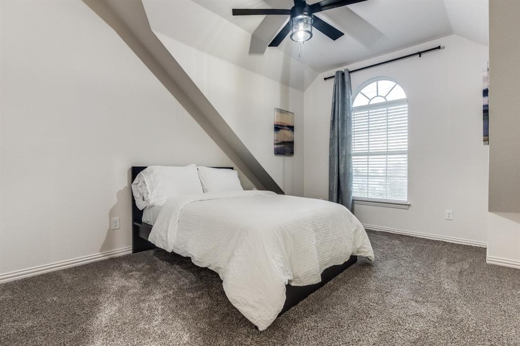 3304 Inwood Road Dallas, TX 75235 - Photo 18 of 24 a bed sitting in a room next to a window