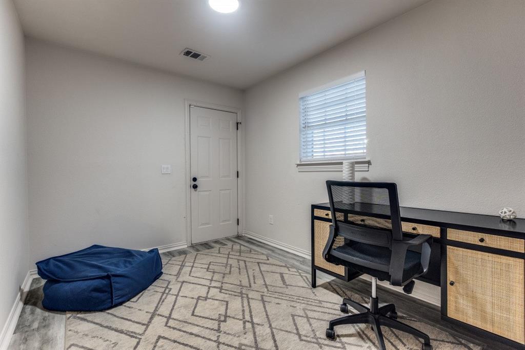 3304 Inwood Road Dallas, TX 75235 - Photo 21 of 24 a bedroom with a bed and a dresser in it