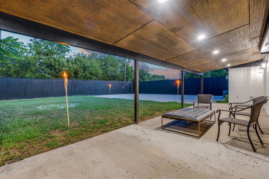 3304 Inwood Road Dallas, TX 75235 - Photo 22 of 24 a view of a chair and table in backyard of the house