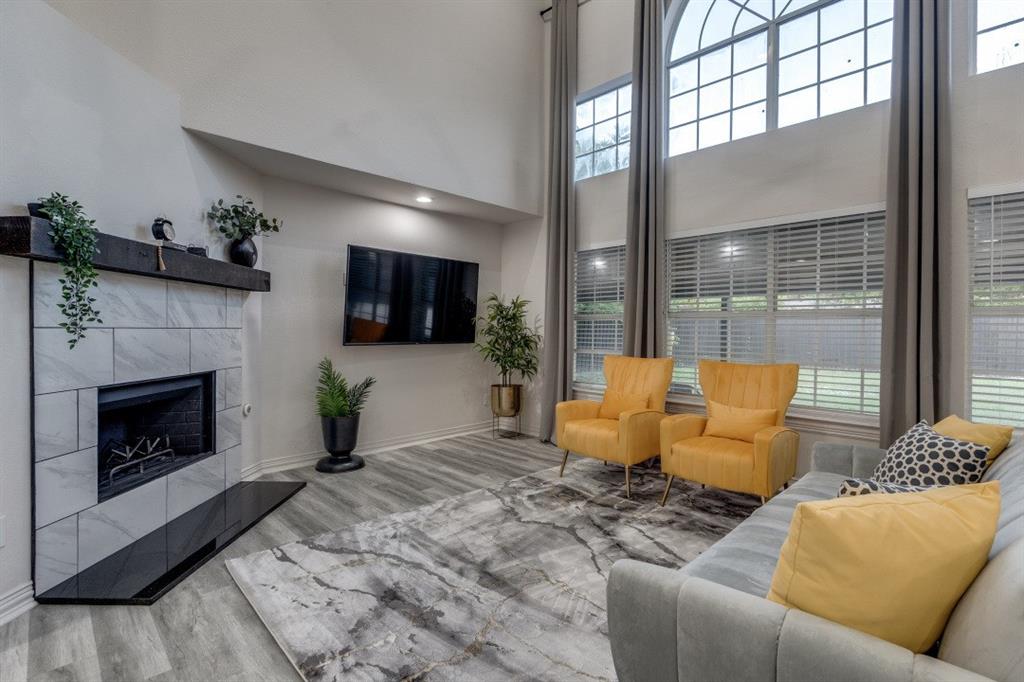 3304 Inwood Road Dallas, TX 75235 - Photo 9 of 24 a living room with furniture a flat screen tv and a fireplace
