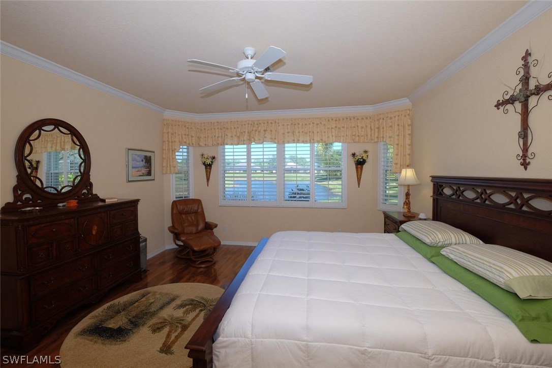 4664 Fairloop Run Lehigh Acres, FL 33973 - Photo 11 of 24 a bedroom with a bed and window