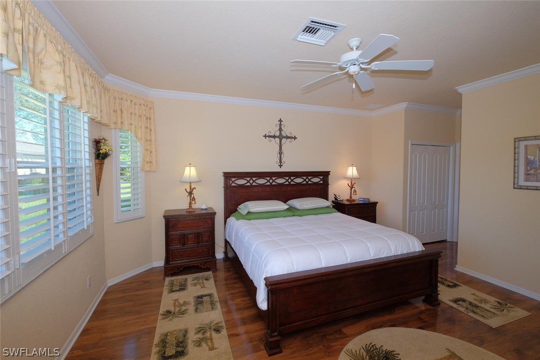 4664 Fairloop Run Lehigh Acres, FL 33973 - Photo 12 of 24 a bed sitting in a bedroom next to a window