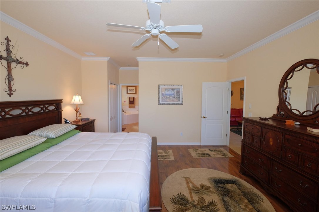 4664 Fairloop Run Lehigh Acres, FL 33973 - Photo 13 of 24 a bedroom with a bed window and dresser