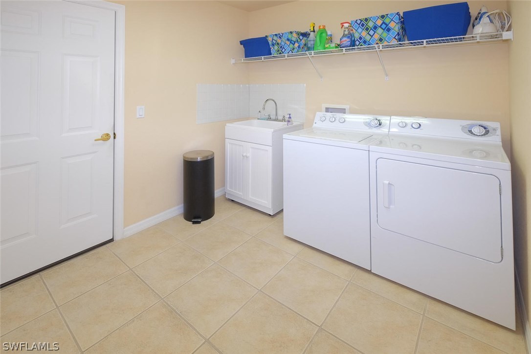 4664 Fairloop Run Lehigh Acres, FL 33973 - Photo 17 of 24 a utility room with dryer and washer