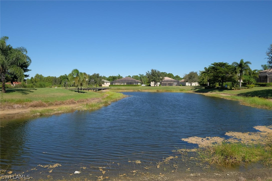 4664 Fairloop Run Lehigh Acres, FL 33973 - Photo 22 of 24 a view of a lake with houses in outdoor space