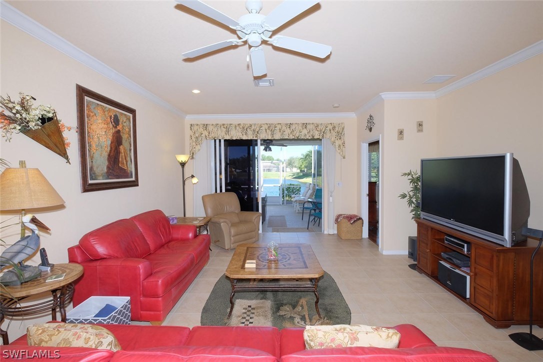 4664 Fairloop Run Lehigh Acres, FL 33973 - Photo 3 of 24 a living room with furniture and a flat screen tv