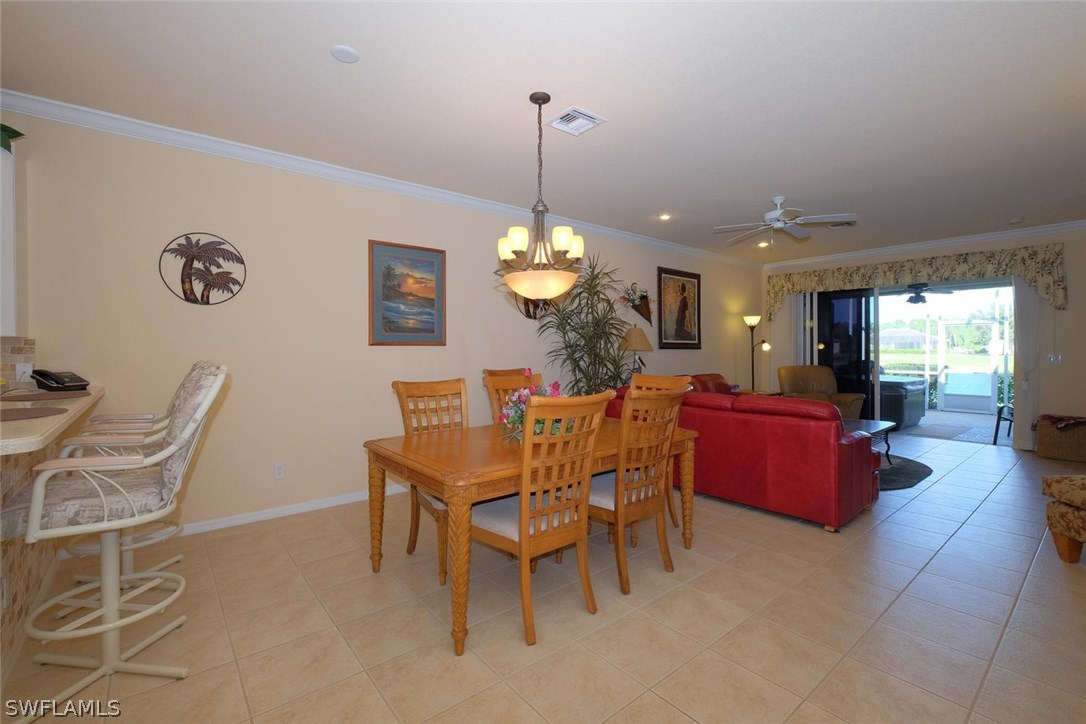 4664 Fairloop Run Lehigh Acres, FL 33973 - Photo 5 of 24 a dining room with furniture and window