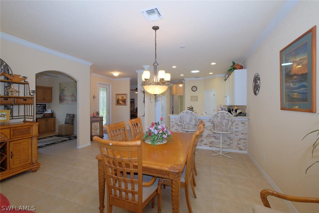 4664 Fairloop Run Lehigh Acres, FL 33973 - Photo 6 of 24 a dining room with furniture and window